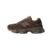 Side view of a brown New Balance 9060 sneaker with toe pointing left, showing the tonal N logo, suede and mesh panels, and chunky layered midsole.