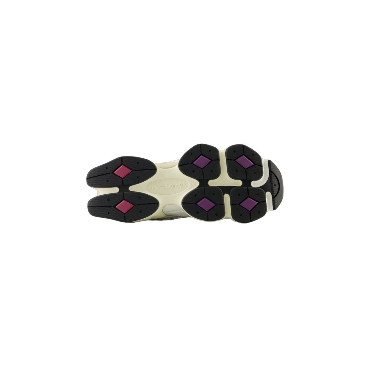 Bottom view of a New Balance 9060 sneaker outsole showing black lugs with pink and purple diamond accents and the New Balance logo molded into the cream midsole
