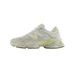 Side view of a cream and off-white New Balance 9060 sneaker with toe pointing left, showing the N logo, mesh panels, and chunky translucent midsole