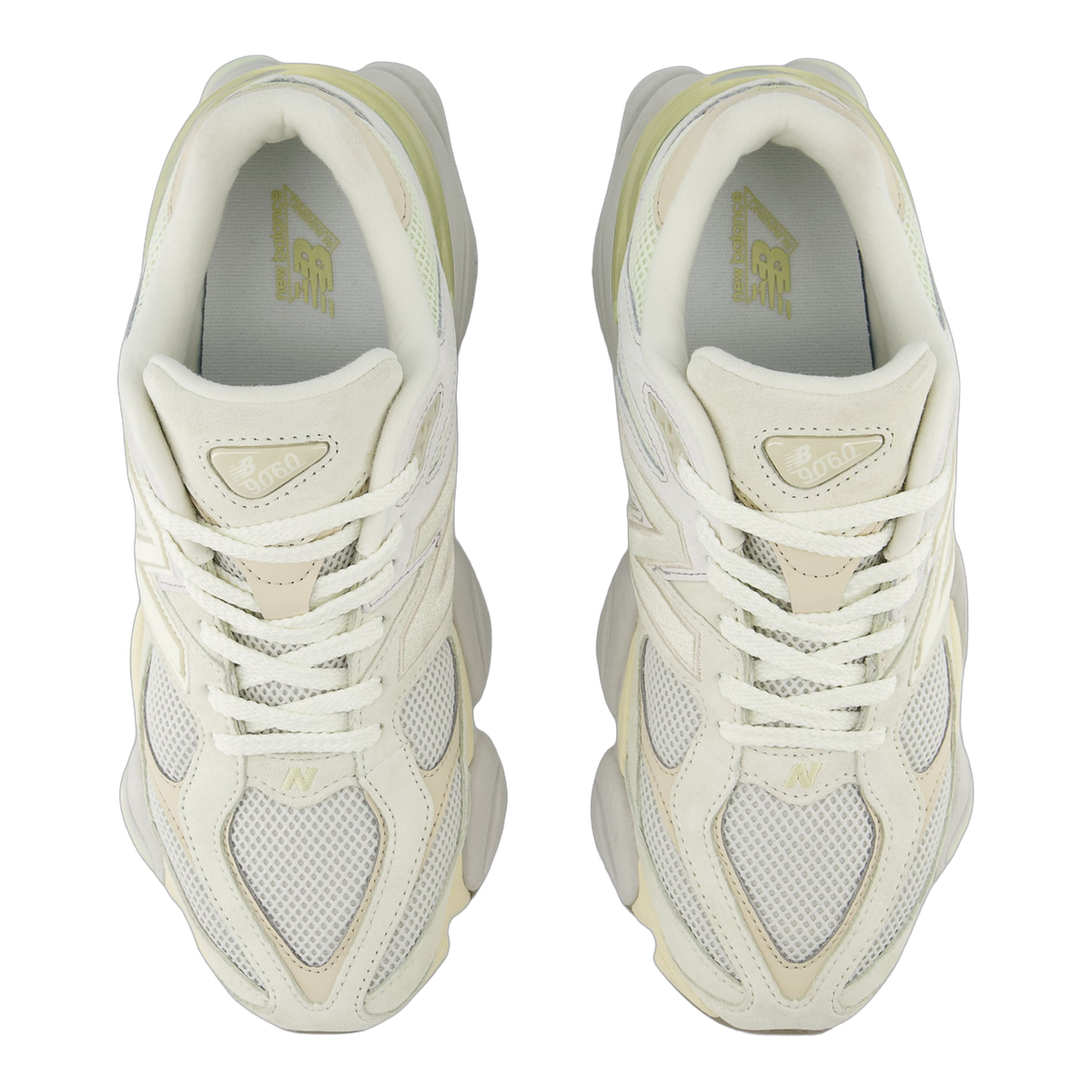 Top-down view of a pair of New Balance 9060 sneakers in off-white and cream tones with mesh panels, suede overlays, and visible 'N' logos and 9060 tongue tags.