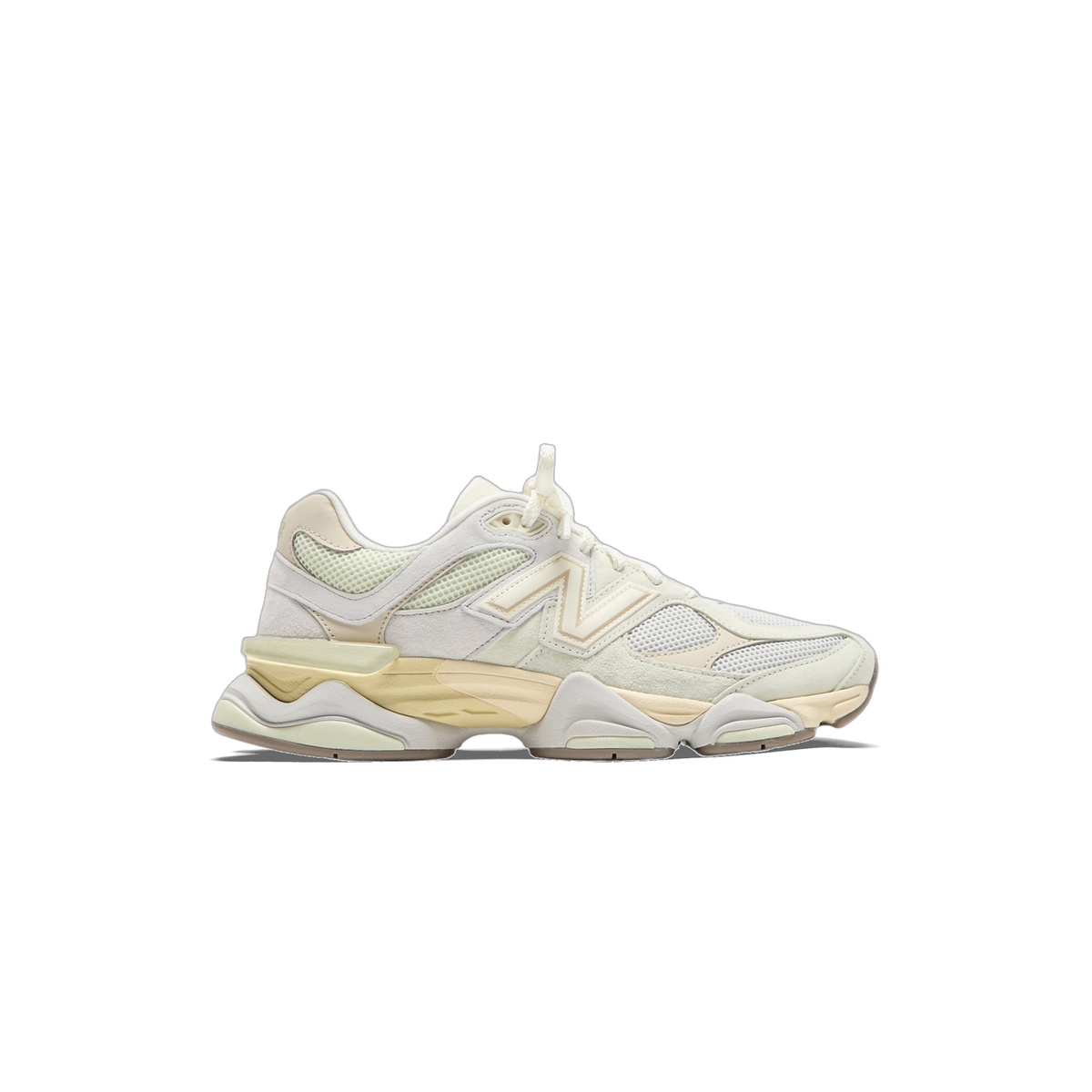 Side view of a cream and off-white New Balance 9060 sneaker with pale yellow midsole and tan N logo, toe pointing left