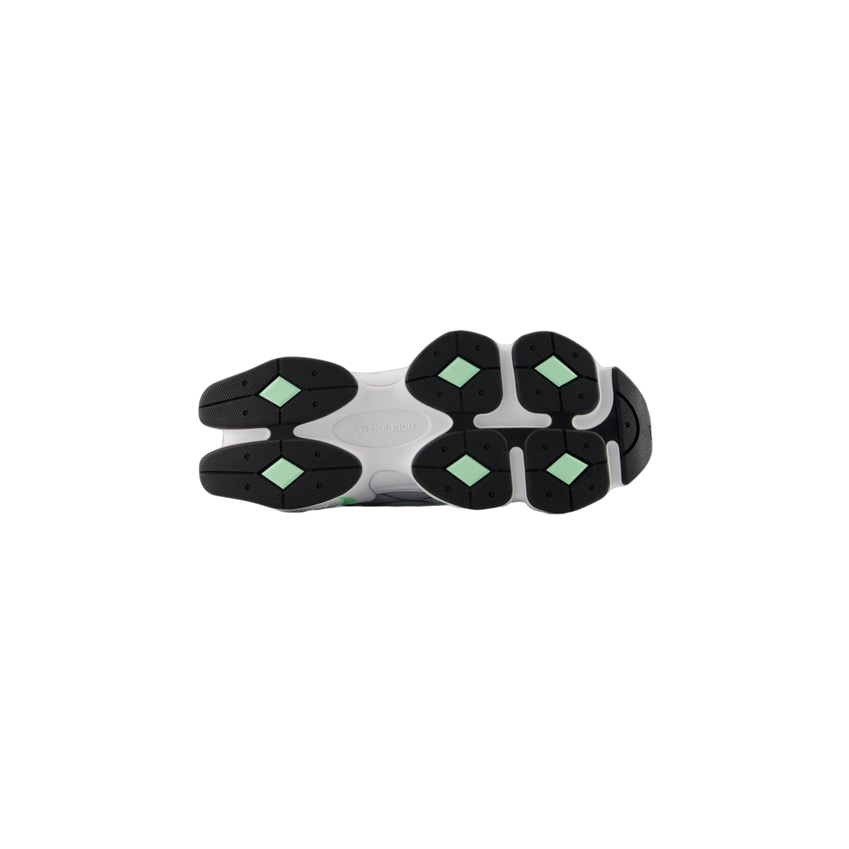Bottom view of a New Balance 9060 sneaker outsole showing a white midsole with black lugs and mint green accents, with New Balance text molded in the center