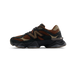 Left shoe lateral view of a New Balance 9060 in black, brown, and beige with the N logo facing outward and toe pointing left