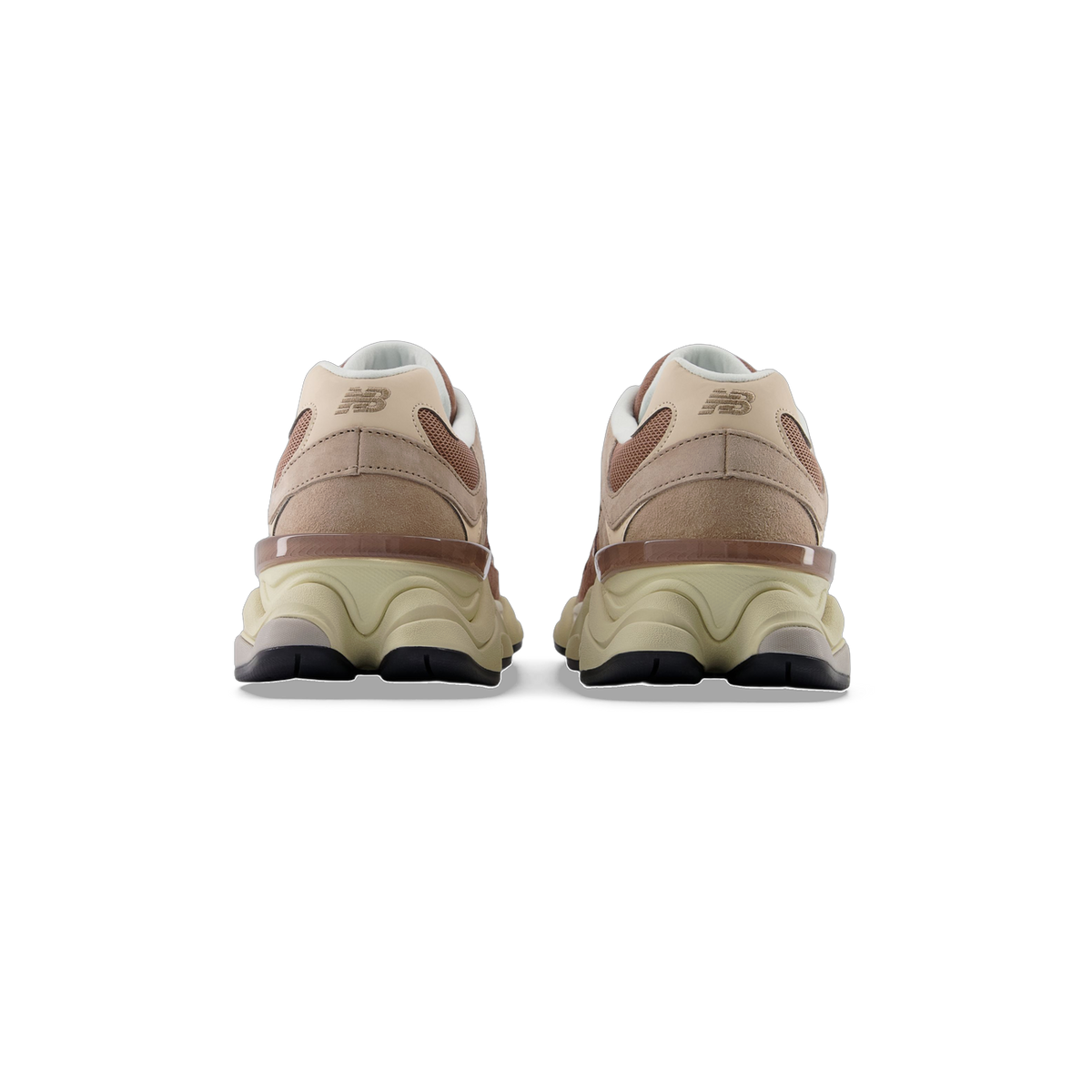 Rear view of a pair of New Balance 9060 sneakers in tan and brown tones with a translucent heel clip and cream midsole
