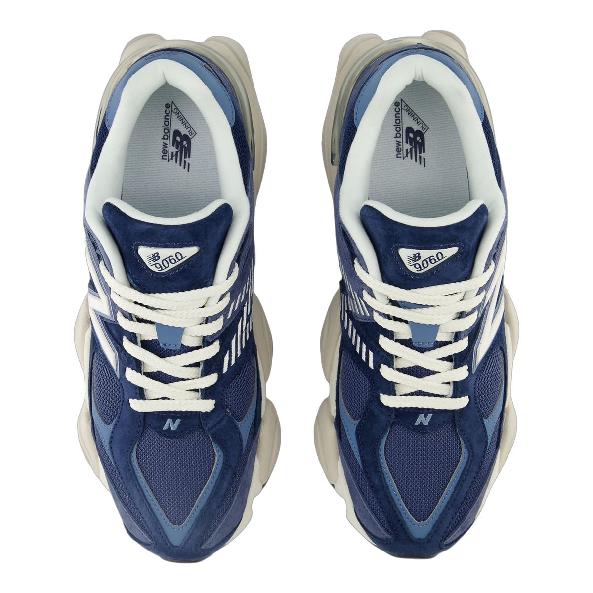 Top-down view of a pair of navy blue New Balance 9060 sneakers with white laces, cream soles, and grey insoles showing the New Balance Running logo and 9060 tongue tags