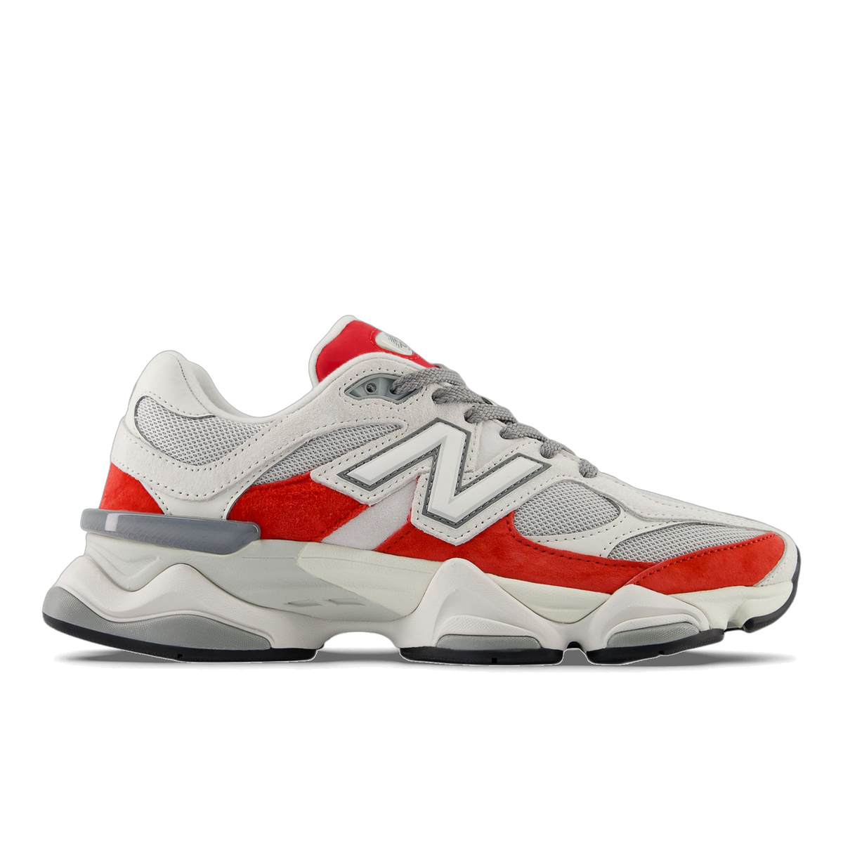 Side view of a white and red New Balance 9060 sneaker with grey mesh panels and chunky midsole, toe pointing left