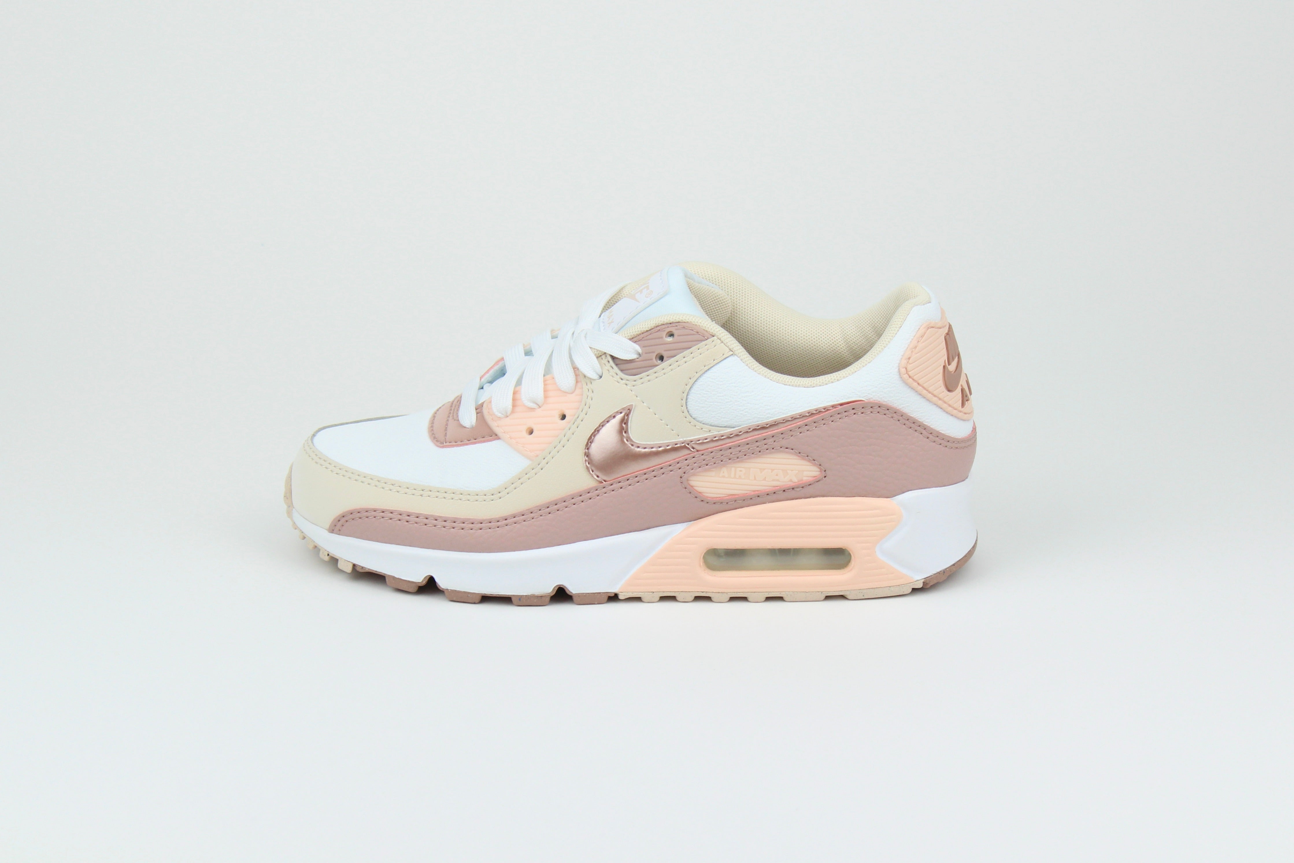 Eco‑friendly Air Max 90 in “Washed Coral” & “Particle Pink” with visible Air cushioning. Limited July 2025 release. Shop now at The Attic!