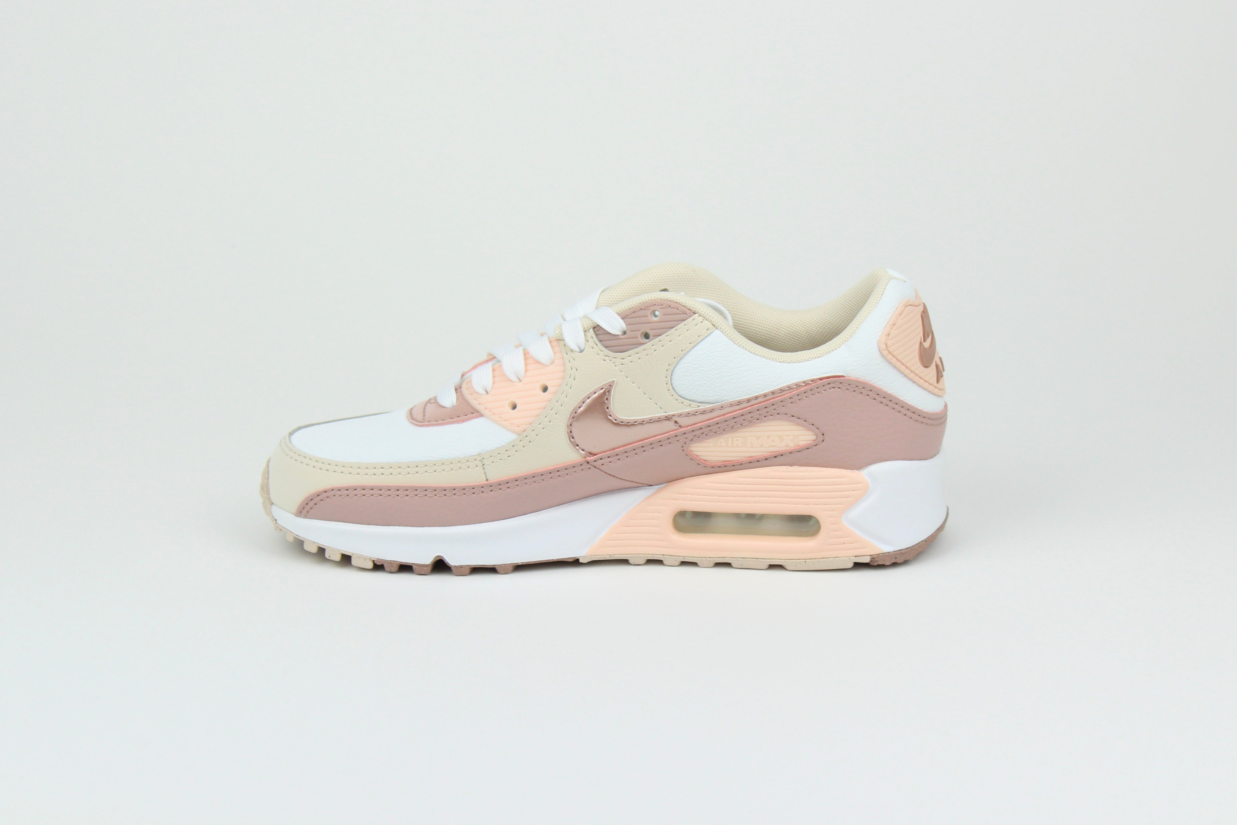 Eco‑friendly Air Max 90 in “Washed Coral” & “Particle Pink” with visible Air cushioning. Limited July 2025 release. Shop now at The Attic!