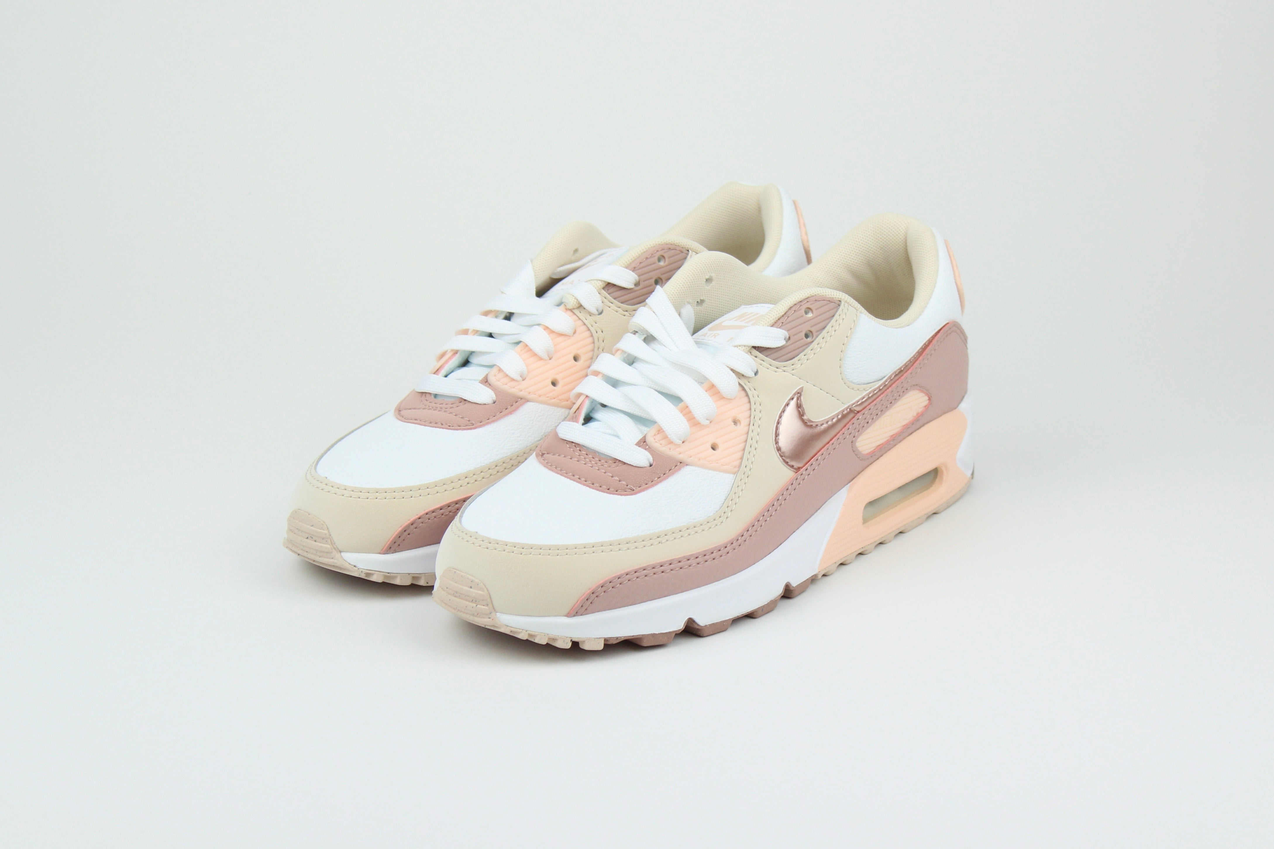 Eco‑friendly Air Max 90 in “Washed Coral” & “Particle Pink” with visible Air cushioning. Limited July 2025 release. Shop now at The Attic!