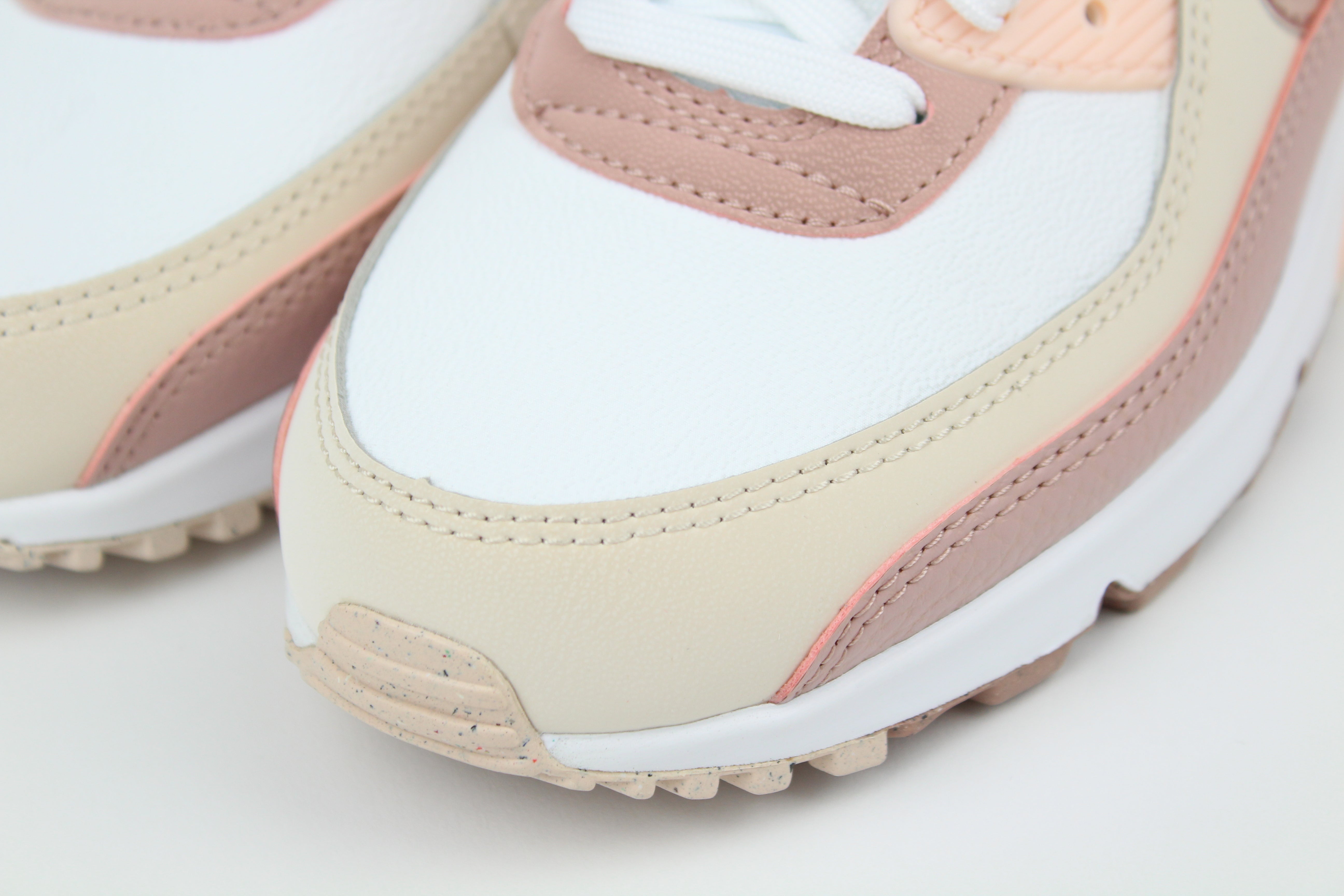 Eco‑friendly Air Max 90 in “Washed Coral” & “Particle Pink” with visible Air cushioning. Limited July 2025 release. Shop now at The Attic!