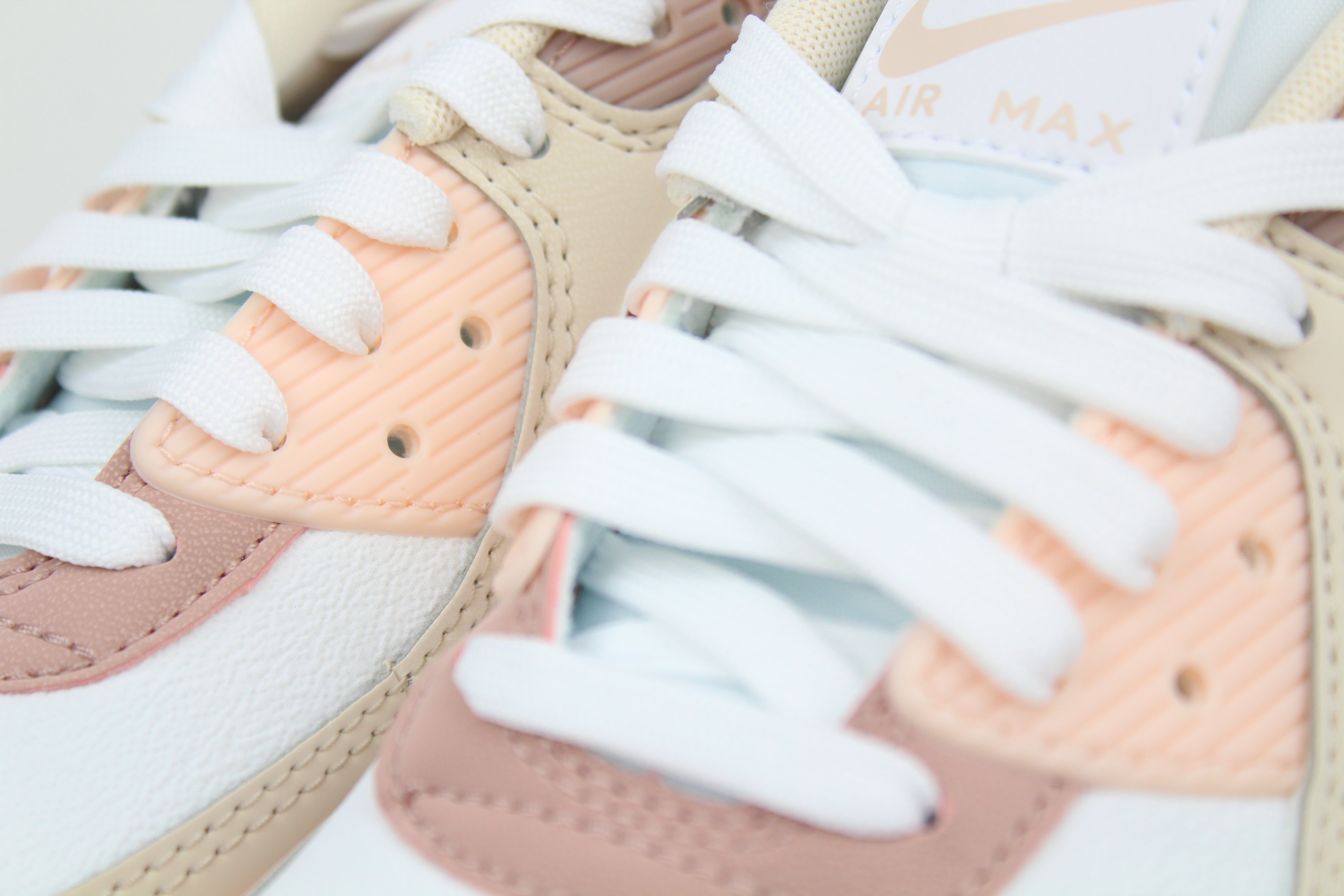 Eco‑friendly Air Max 90 in “Washed Coral” & “Particle Pink” with visible Air cushioning. Limited July 2025 release. Shop now at The Attic!