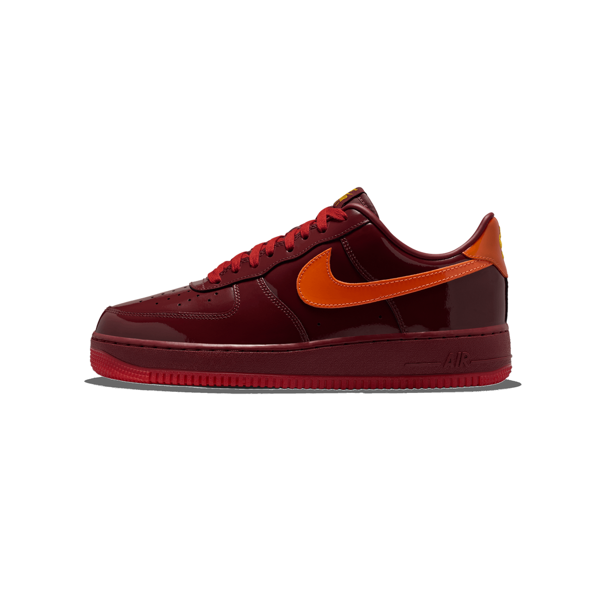 Side view of a dark red patent leather Nike Air Force 1 Low with an orange Swoosh logo and red laces, toe pointing left.
