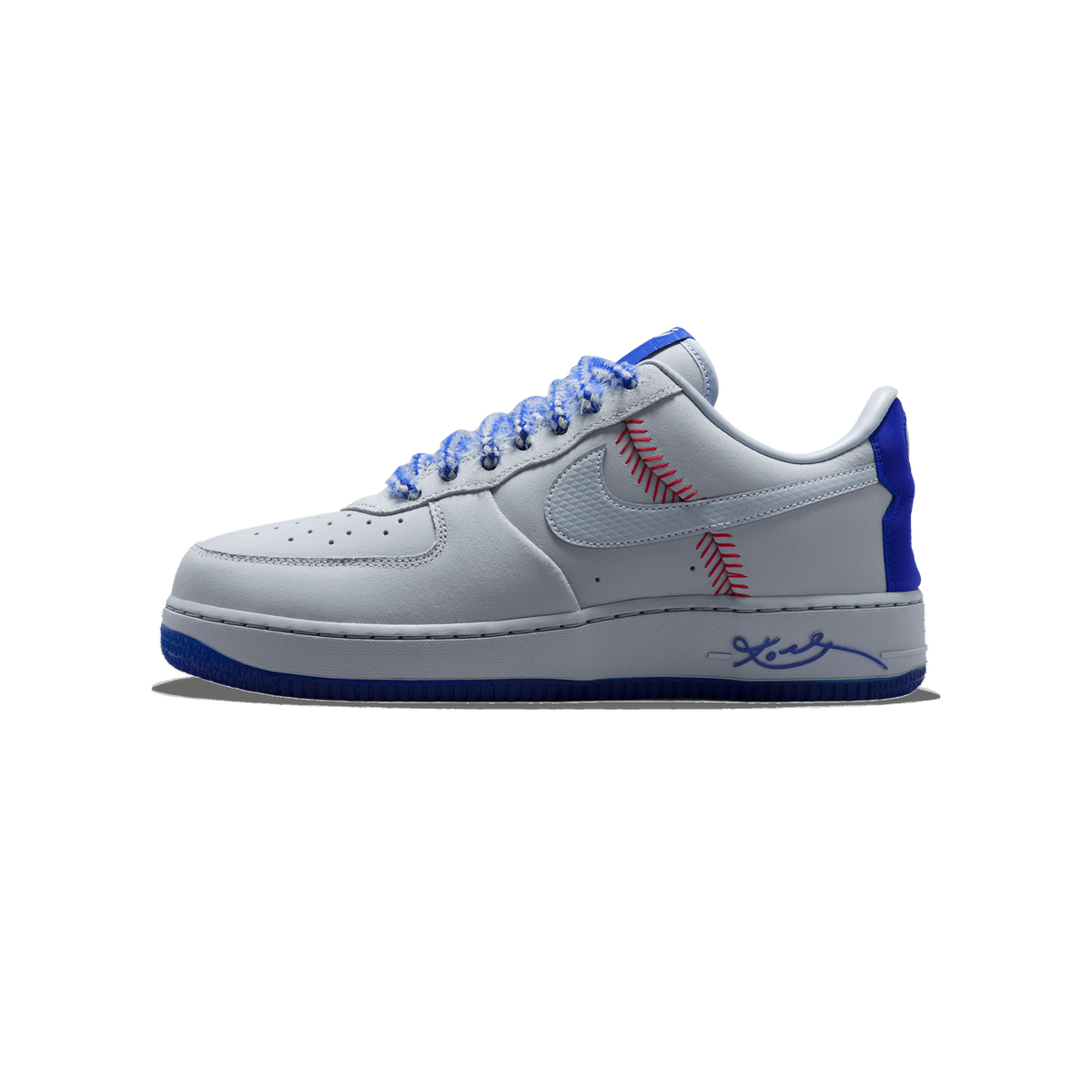 Lateral view of a white Nike Air Force 1 Low with red baseball-stitch detailing, blue heel tab, mottled blue laces, and a signature script on the midsole, toe pointing left.