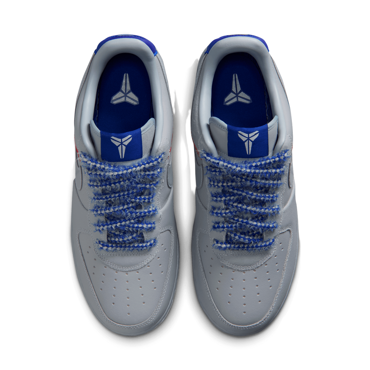 Top-down view of a pair of grey Nike Air Force 1 Low Protro sneakers with blue woven laces, blue collar lining, and a Kobe Bryant sheath logo on the blue tongue tabs.