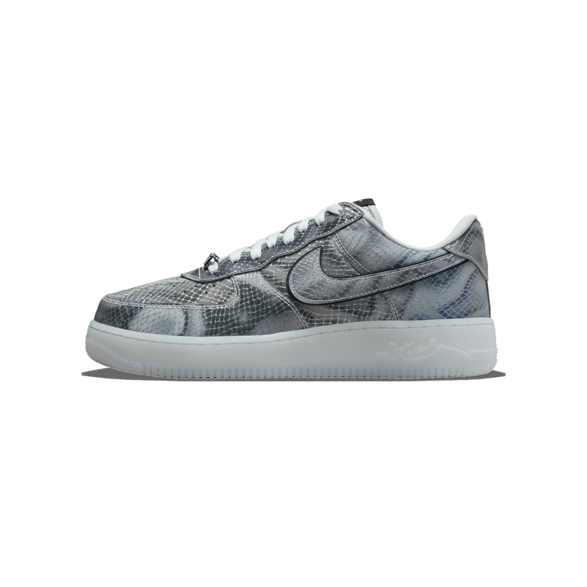 Single Nike Air Force 1 Low shoe in a grey, silver and iridescent snakeskin-patterned upper with a black-outlined Swoosh, white laces, a frosted translucent sole, and a small metal charm on the lace area, shown from the lateral side with the toe poin