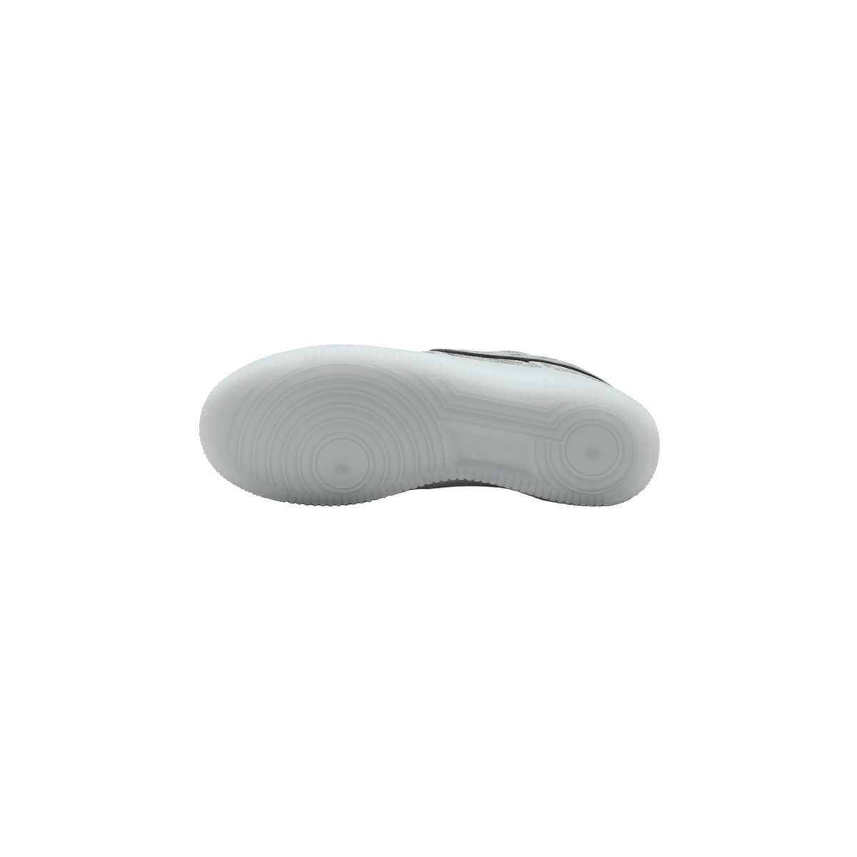 Underside of a white Nike sneaker showing the translucent white outsole with circular tread pattern and a small Nike swoosh logo near the midfoot, with a glimpse of the upper's black and light patterned material at the edge.