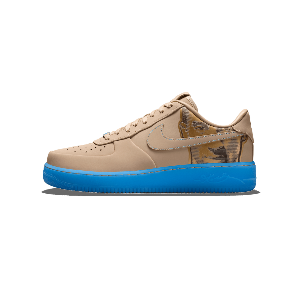 Side profile of a single beige Nike Air Force 1 Low with a tan upper, a golden-brown printed graphic on the heel panel, a blue Swoosh with blue stitching, and a bright blue translucent midsole, toe pointing left.