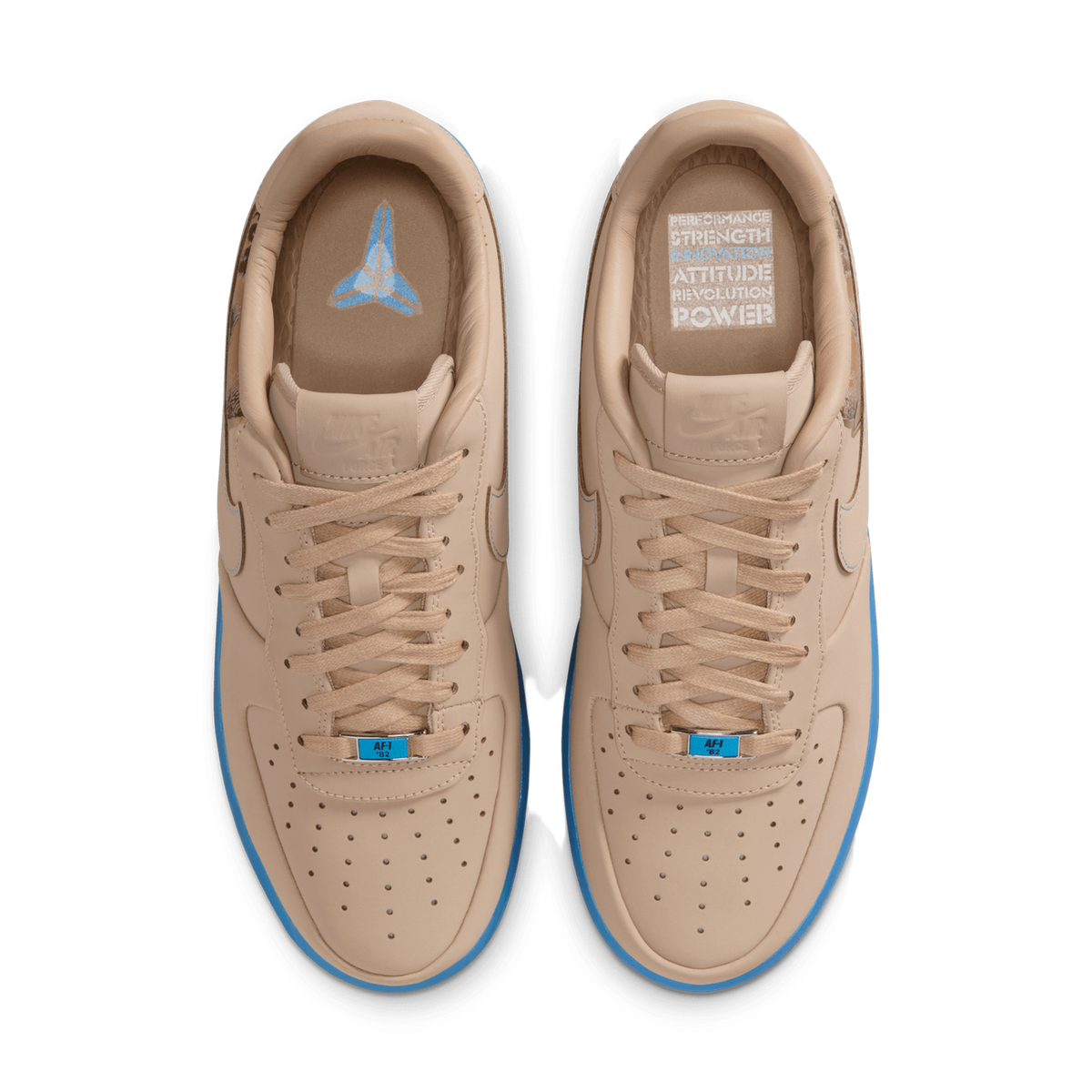 Overhead top-down view of a pair of beige linen Nike Air Force 1 Low sneakers with light blue midsoles, laces tied, toes pointing up, showing the tongues and insoles with blue and white printed graphics.