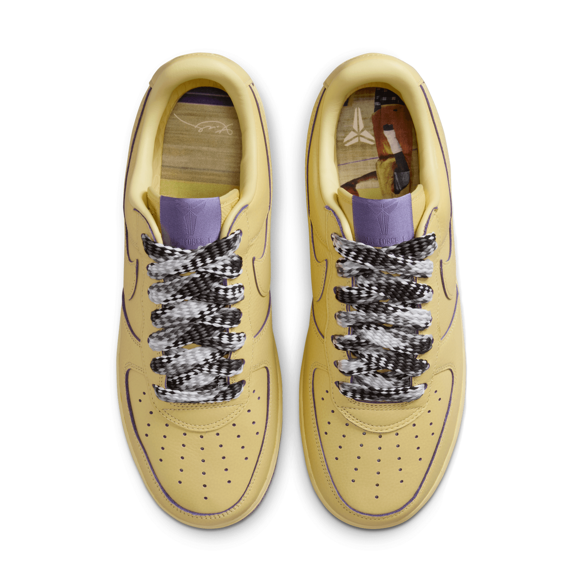 Top-down view of a pair of yellow Nike Air Force 1 Low sneakers placed side by side with toes pointing up, showing purple piping, checkered black-and-white laces, and purple-and-patterned insoles visible inside the collars.