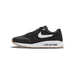 Side view of a black Nike Air Max 1 '86 golf shoe with white Swoosh, speckled white midsole, visible air bubble unit, and gum outsole, toe pointing left.