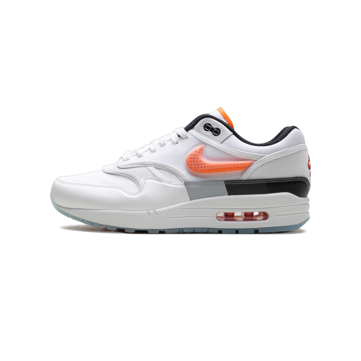 Left Nike Air Max 1 '87 sneaker in white with an orange glowing swoosh, black heel panel, and visible Air unit in the midsole, toe pointing left