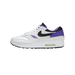 Left shoe side view of a white Nike Air Max 1 sneaker with black swoosh, purple accents on heel and midfoot, and visible air unit in the white midsole