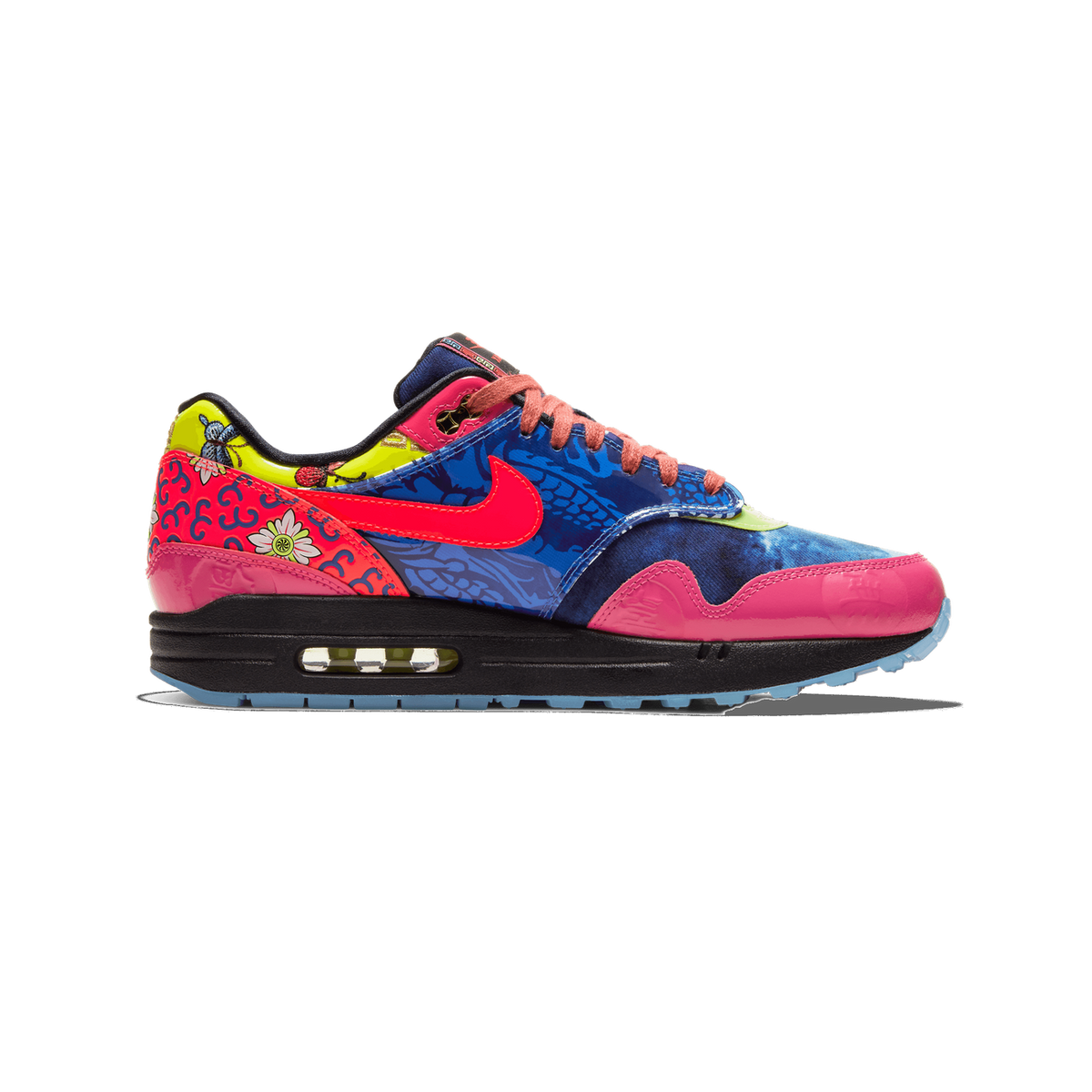 Lateral view of a Nike Air Max 1 sneaker with a multicolor blue floral, pink, yellow, and red patterned upper, crimson Swoosh, and black midsole with visible Air unit.