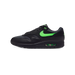 Left Nike Air Max 1 sneaker in black with a green swoosh and visible green Air unit, shown from the side with toe pointing left