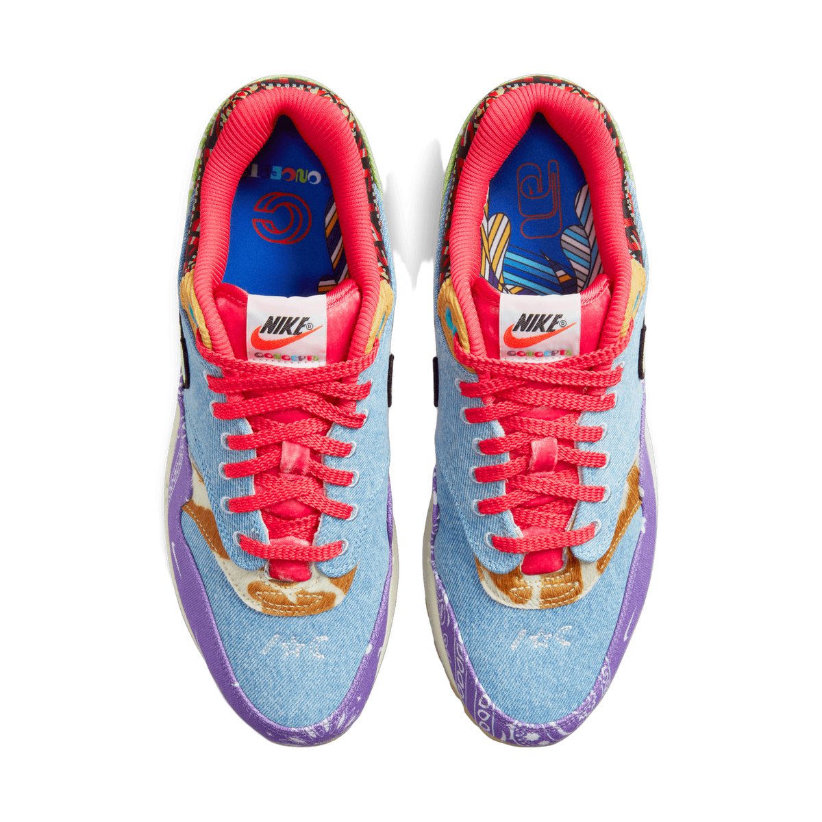 Top-down view of a pair of Nike Air Max 1 sneakers with denim uppers, purple paisley overlays, pink laces, cheetah-print accents, and colorful patterned Concepts-branded tongues and insoles.