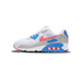 Side view of a white, grey, blue and coral Nike Air Max 90 sneaker with toe pointing left, showing the Swoosh logo and visible Air cushioning unit in the heel