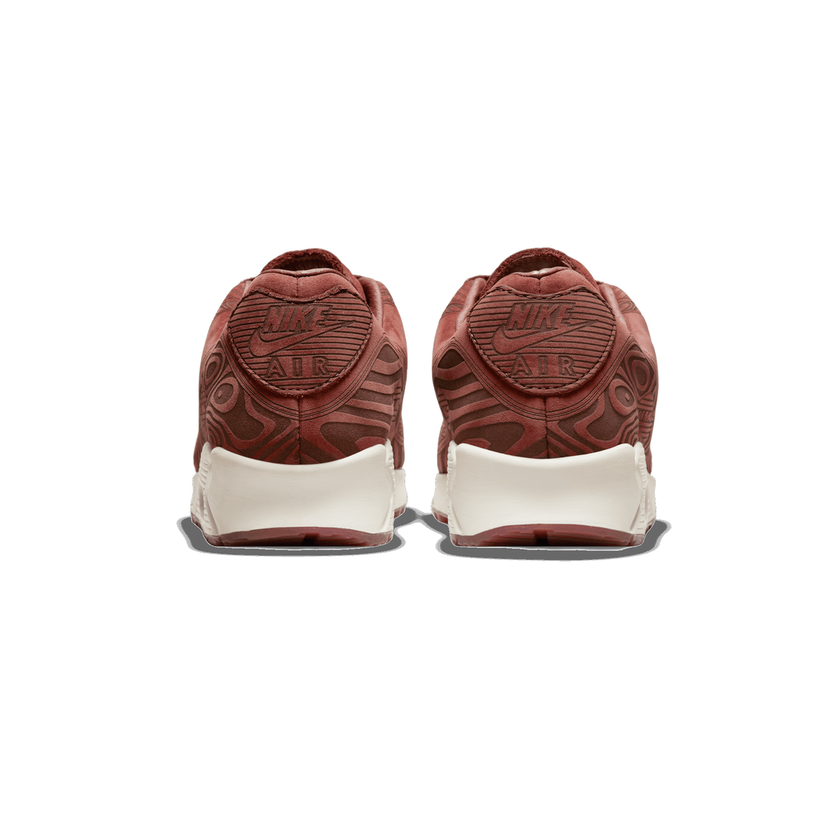 Rear view of a pair of reddish-brown Nike Air Max 90 sneakers with embossed topographic-style patterns, showing the heel tabs with Nike Swoosh and AIR logos and cream-coloured midsoles.