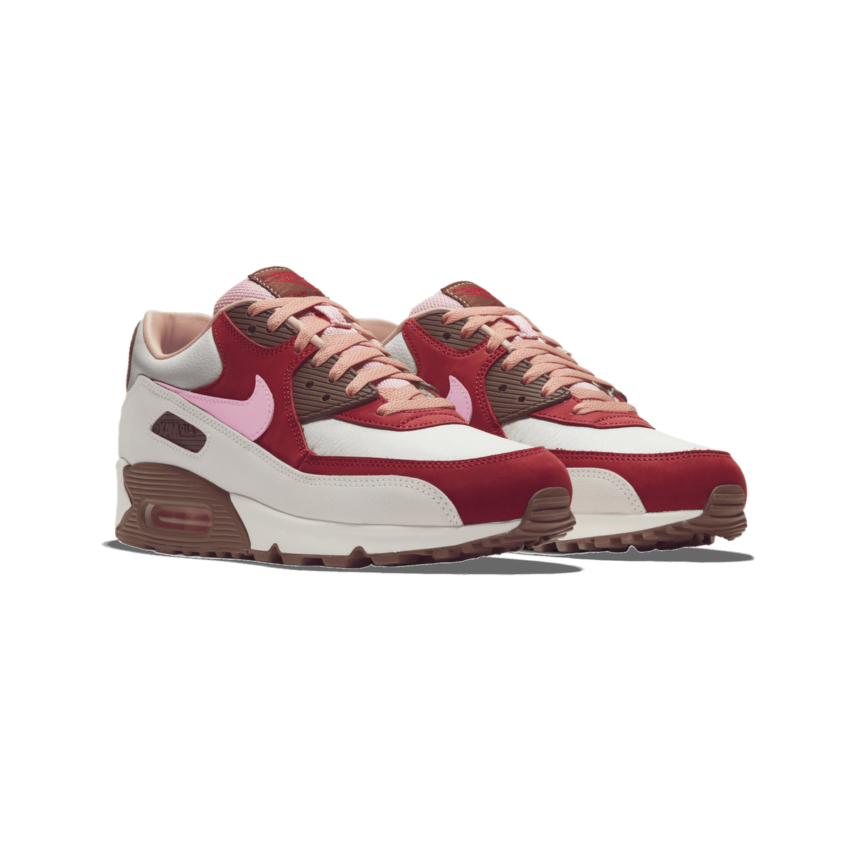 Pair of Nike Air Max 90 NRG sneakers in white, red, brown and pink angled toward the left, showing pink swooshes and visible Air unit in the heel
