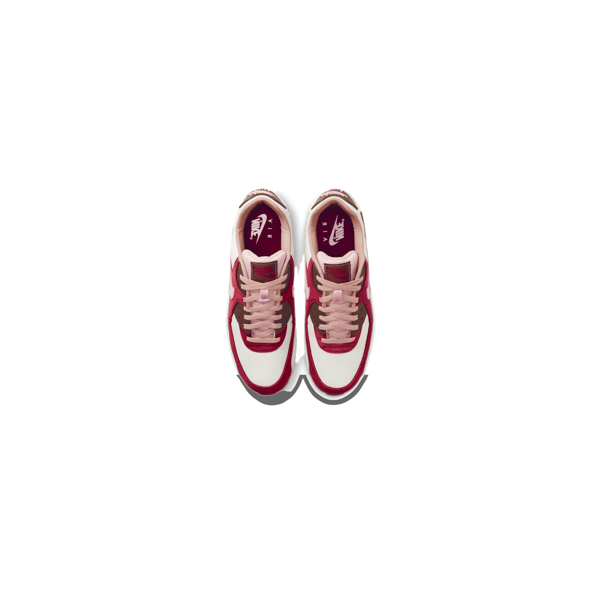 Top-down view of a pair of Nike Air Max 90 sneakers in white, red, brown and pink with Nike branding visible on the tongue and insole