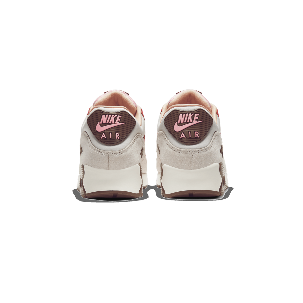Rear view of a pair of white and beige Nike Air Max 90 sneakers with brown Nike Air heel tabs in pink lettering and gum-colored soles.