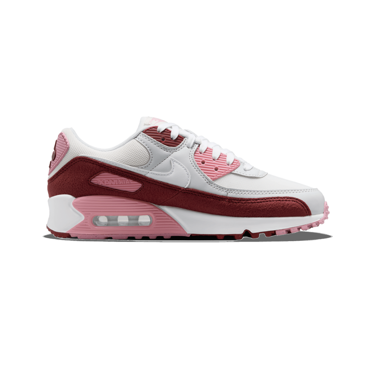 Side profile of a white, pink and dark red Nike Air Max 90 sneaker, toe pointing left, showing the Nike swoosh, layered suede-look panels, and the visible pink Air Max unit in the midsole.