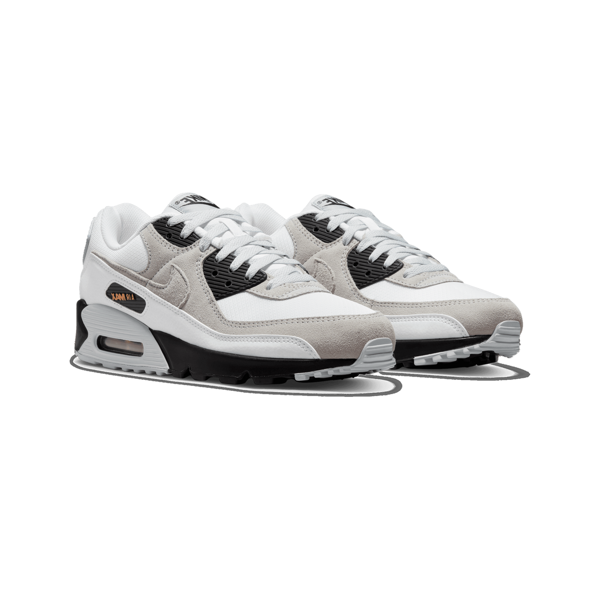 Front-angled view of a pair of Nike Air Max 90 sneakers in white and grey with black heel and lace panels and orange Air Max branding on the midsole.