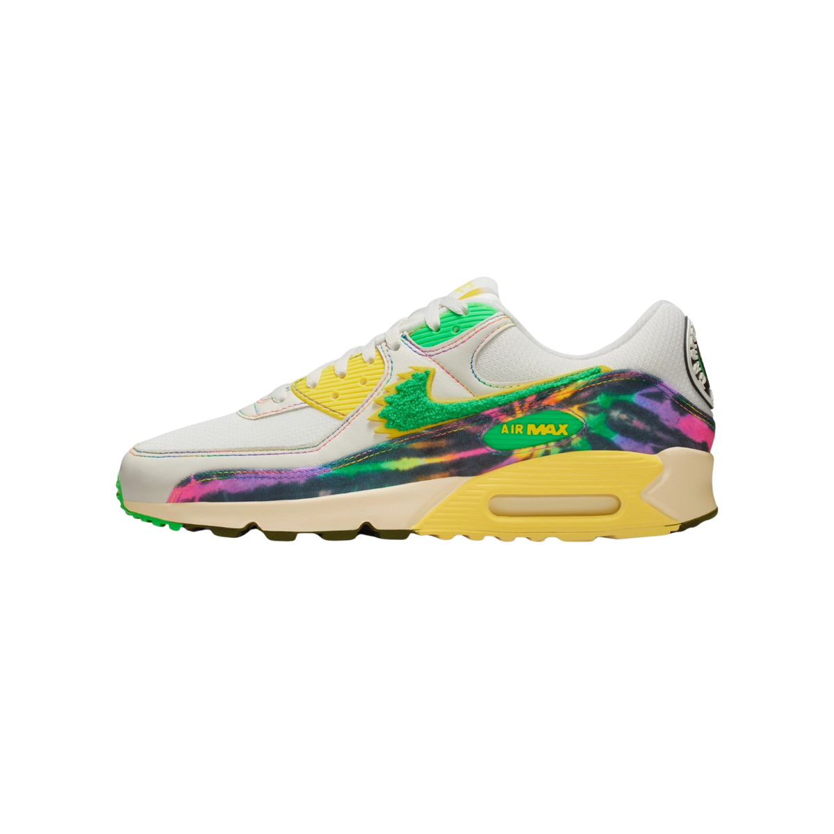 Left Nike Air Max 90 sneaker shown from the side with a white upper, green chenille swoosh, yellow laces and heel, and a tie-dye multicolor overlay on the midfoot and heel panel
