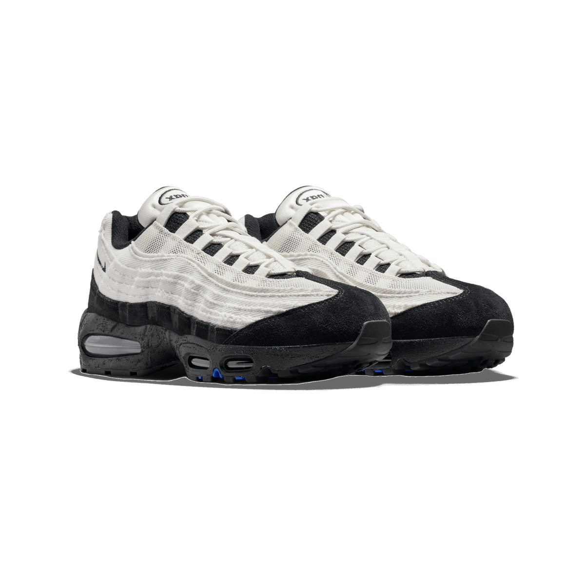 A pair of Nike Air Max 95 sneakers in black and white with frayed off-white panels, black suede toe caps, and black-and-gray speckled midsoles, shown side by side angled to the left.