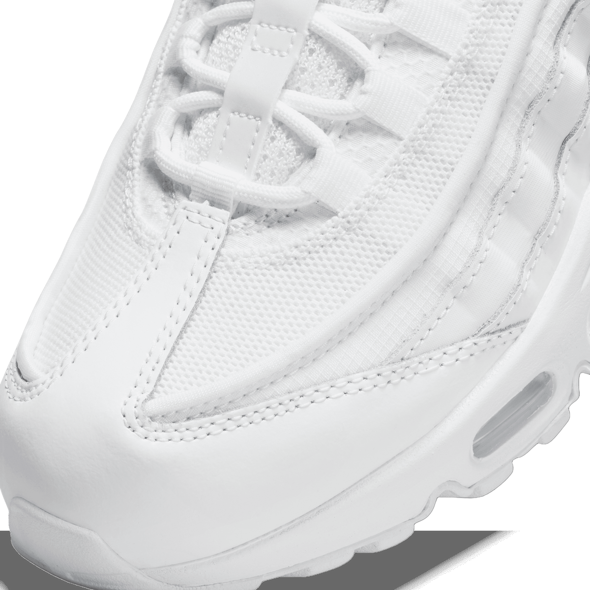 Close-up of the toe box and lacing area of a white Nike Air Max 95, showing mesh panels, layered stitching, and the visible Air cushioning unit near the sole.