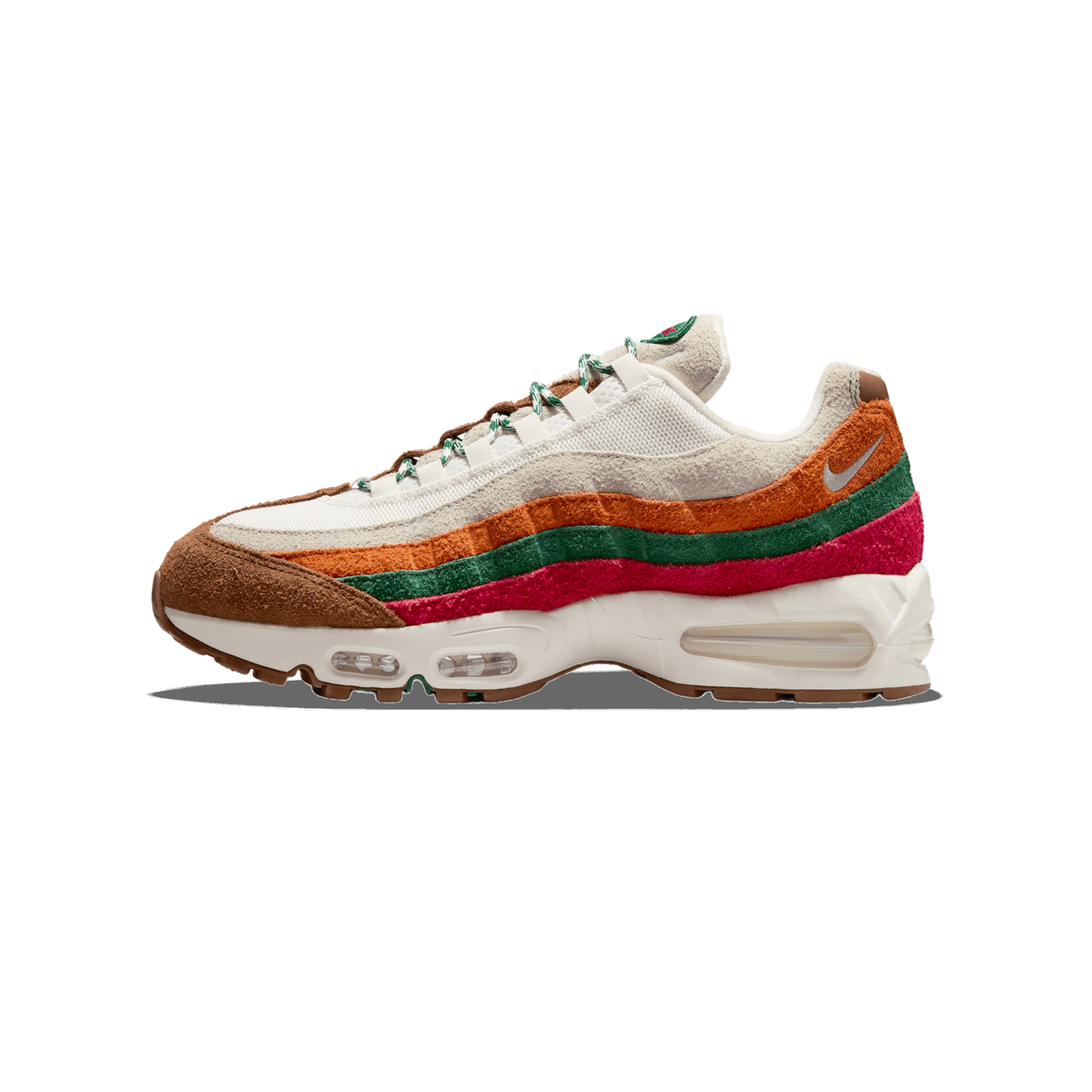 Left Nike Air Max 95 sneaker shown from the outside with toe pointing left, featuring layered wavy panels in orange, green, pink and brown suede over a cream mesh base and gum outsole.