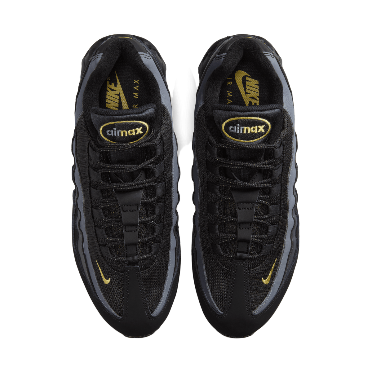Top-down view of a pair of black Nike Air Max 95 sneakers side by side, toes pointing up, showing grey panels, gold Swoosh logos on the sides and tongues, and gold-embroidered 'airmax' tongue labels.