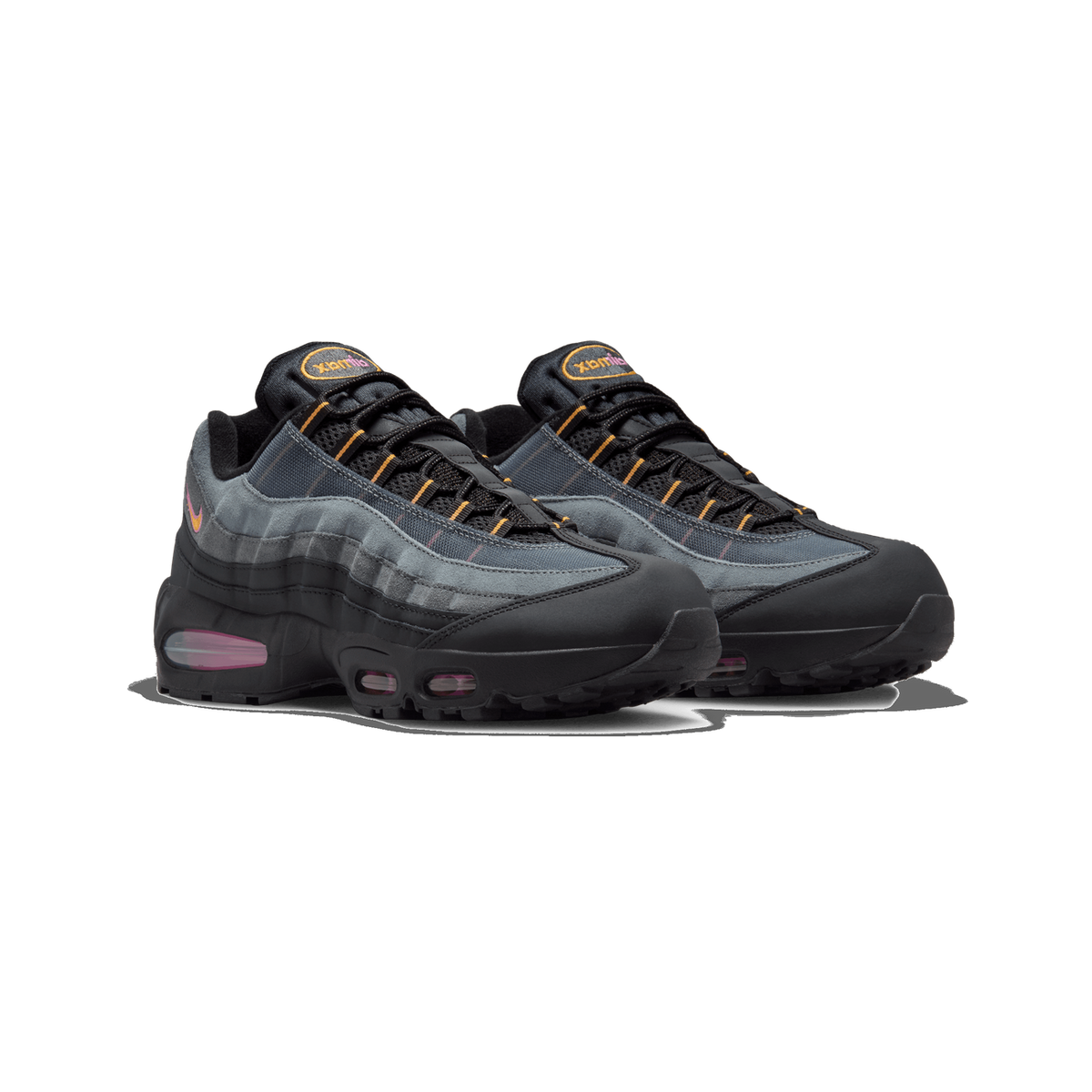 Pair of black and grey Nike Air Max 95 sneakers shown side by side at a three-quarter angle, with orange and pink accents on the laces, tongue logo, and visible Air units along the midsole.