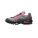 Side profile of a single Nike Air Max 95 sneaker with the toe pointing left, showing a grey and white mesh and suede upper with red accents on the laces, tongue, and Swoosh logo, and visible clear Air units in the black midsole.