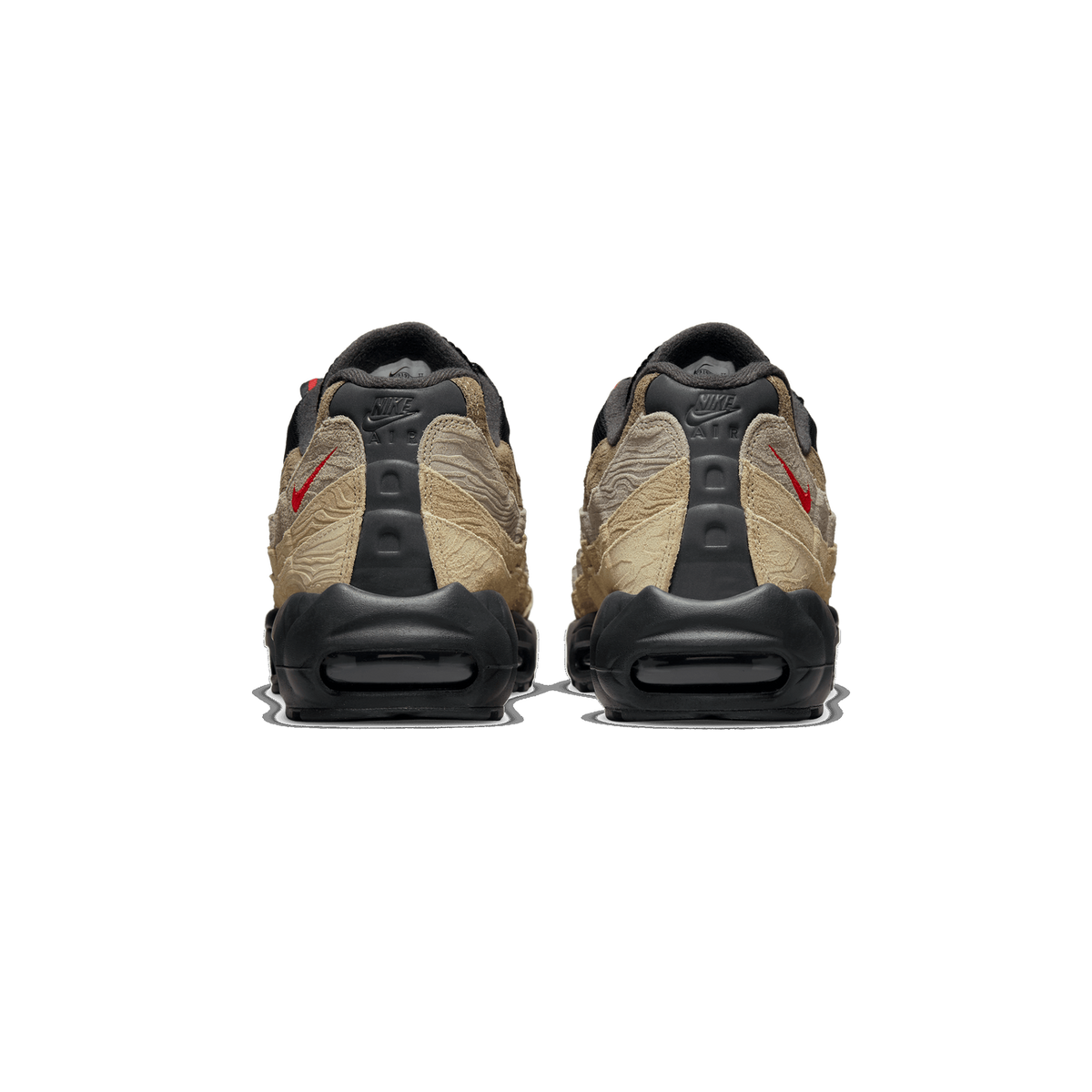 Rear view of a pair of Nike Air Max 95 sneakers on a white background, showing the black heel counters with Nike and Air branding, beige and tan topographic-patterned overlays, red Swoosh accents, and black Air units at the heels.
