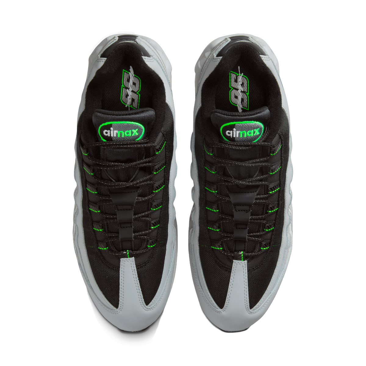 Top-down view of a pair of Nike Air Max 95 sneakers placed side by side, showing black mesh uppers with light grey overlays, bright green laces and stitching, and green-outlined airmax branding on the tongues and insoles.