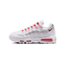 Lateral view of a white Nike Air Max 95 SE sneaker with red laces, silver ribbed panels, a red heel Air unit, and a black-outlined red swoosh.