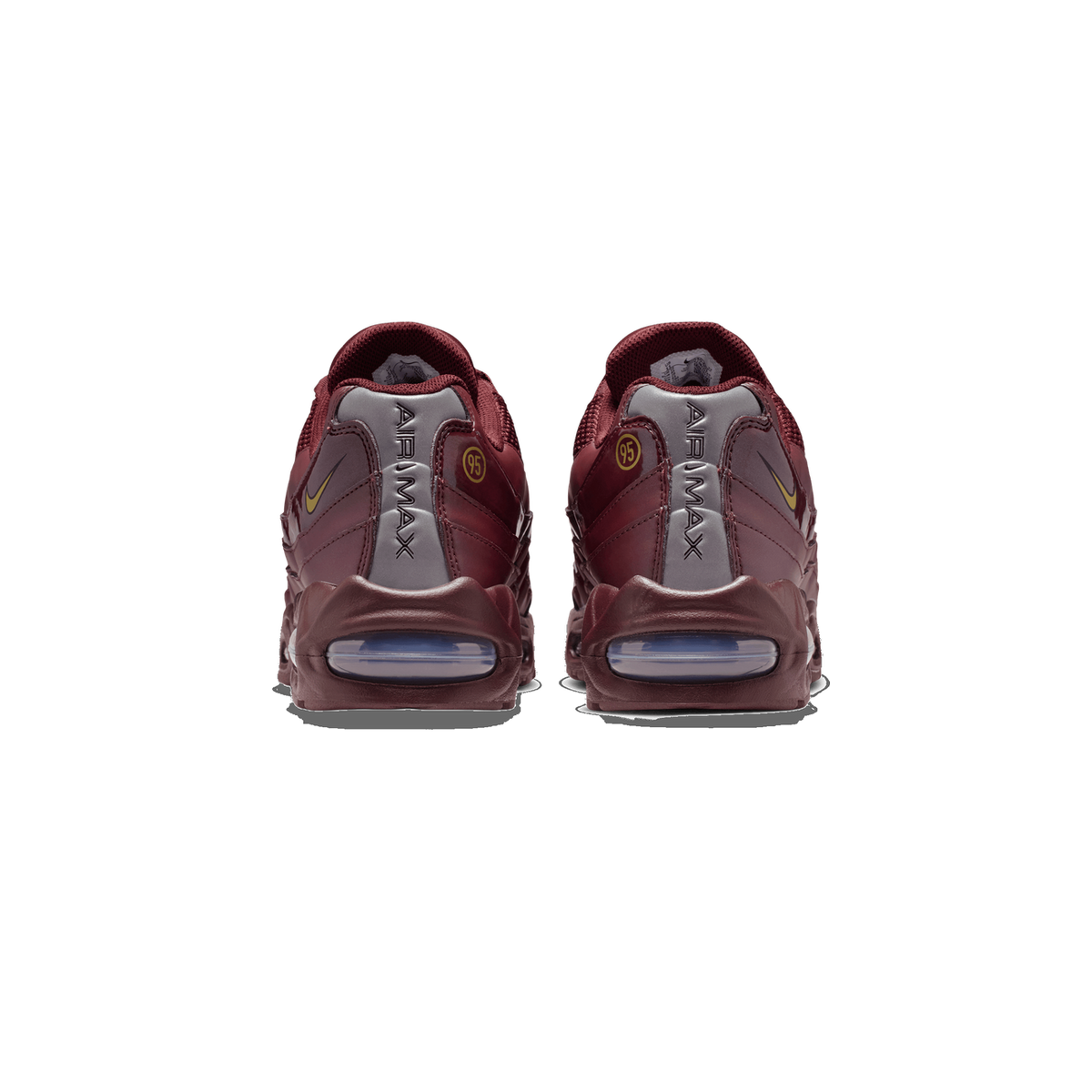 Rear view of a pair of burgundy Nike Air Max 95 sneakers standing side by side on a white background, showing the heel counters with 'AIR MAX' lettering, gold Swoosh logos, gold '95' badges, and visible air units at the heels.