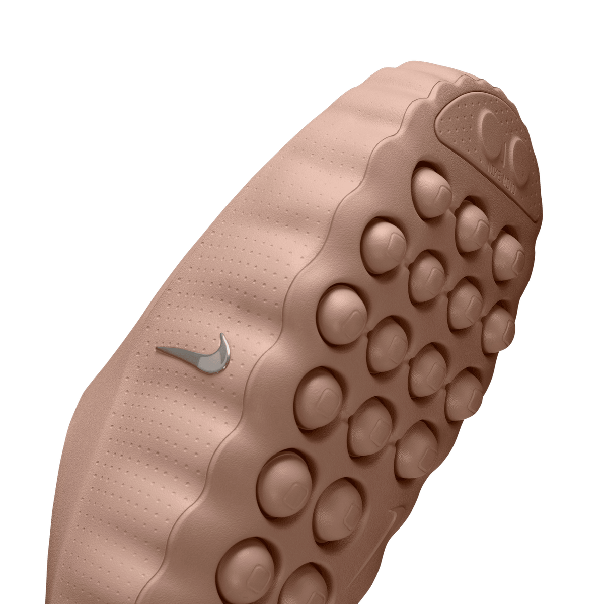 Close-up angled view of the tan rubber outsole of a Nike Mind shoe showing a bumpy knobbed tread pattern and silver Nike swoosh logo.