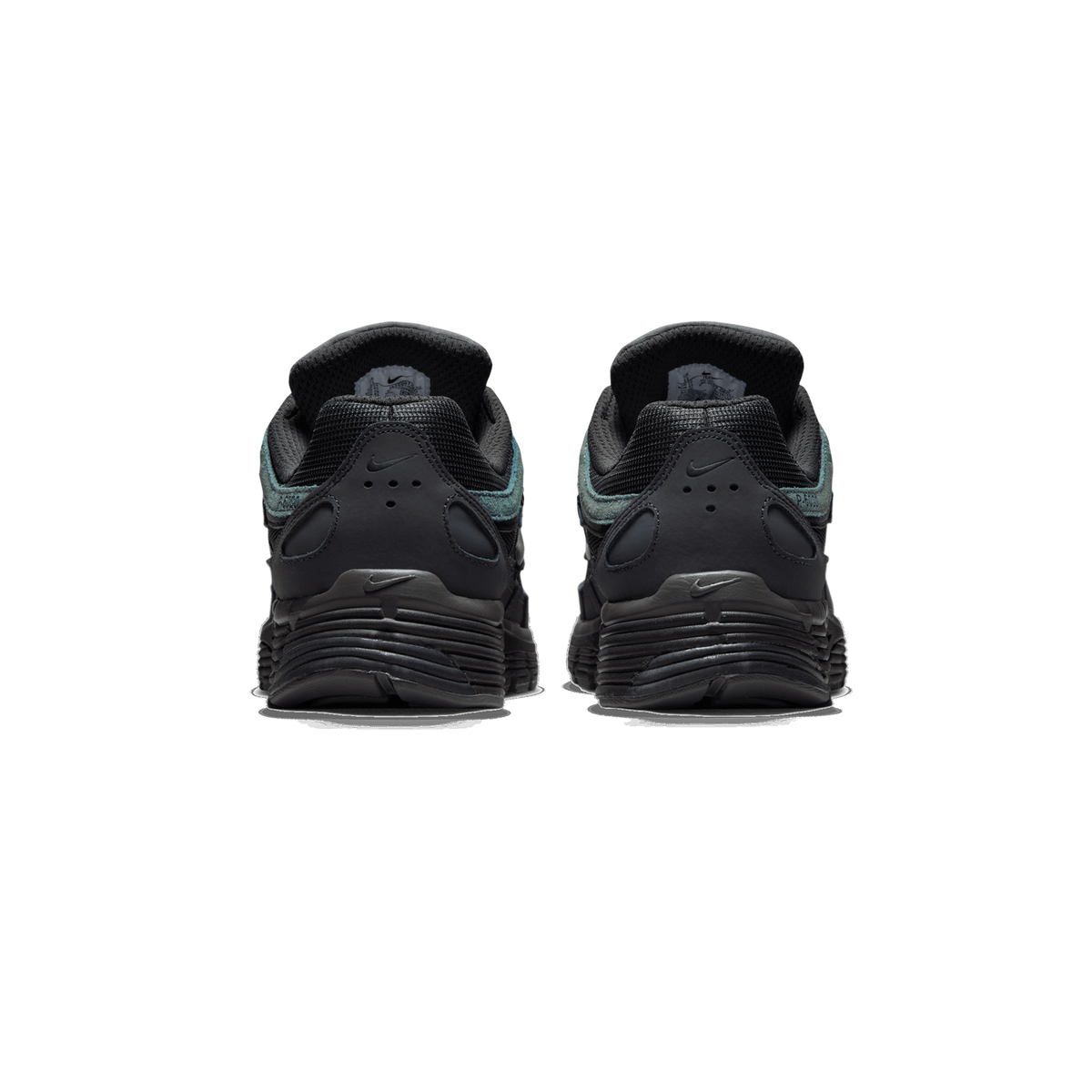Rear view of a pair of black and dark grey Nike P-6000 sneakers on a white background, showing the heel counters with small Nike swoosh logos, the teal-green suede accents along the collar edges, and the ribbed black rubber outsoles.