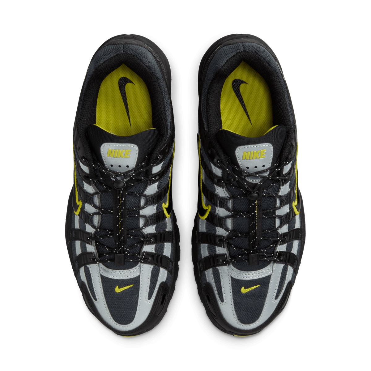 Top-down view of a pair of Nike P-6000 sneakers placed side by side, showing black and grey mesh and overlays with yellow accents, yellow Nike logos on the tongues and insoles, and black laces with a reflective cord and toggle.